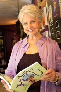 Judith Briles holding her book