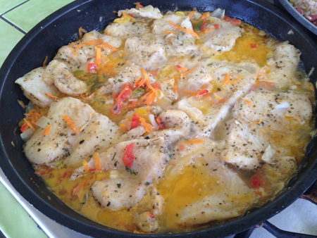 Skillet of simmering fish